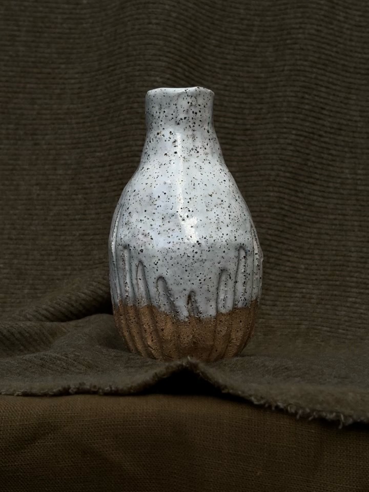 Speckled white-glazed vase with raw clay base